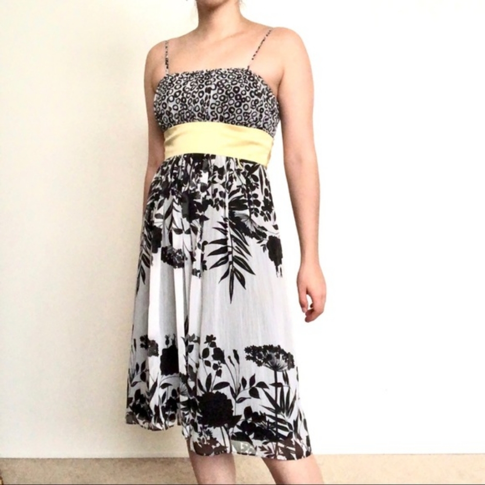 Black and white cocktail dress with yellow tie at waist